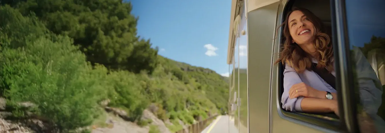 Actor portrayal of a woman looking out an RV window