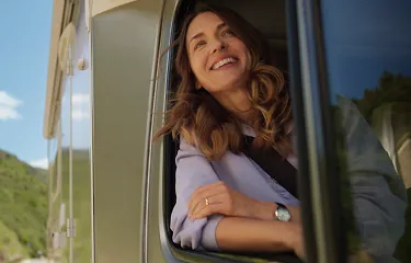 Actor portrayal of a woman looking out an RV window